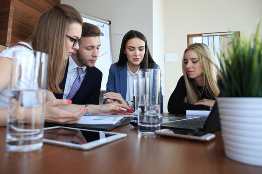 startup business team on meeting in modern bright office interior brainstorming, working on laptop and tablet computer