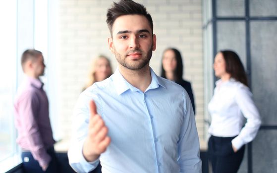 A business man with an open hand ready to seal a deal