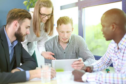 Image of business partners discussing documents and ideas at meeting