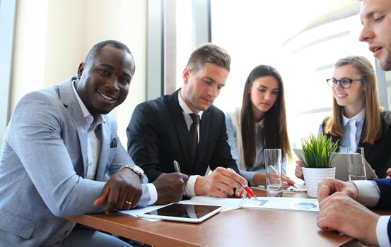 Business team discussing together business plans in office