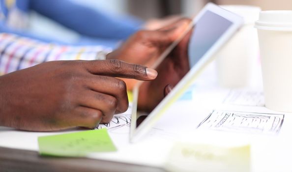 Close-up image of an office worker using a touchpad to analyze statistical data