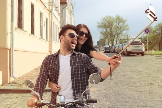 Young beautiful couple riding on motorbike. Adventure and vacations concept.