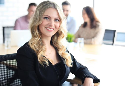 business woman with her staff, people group in background at modern bright office indoors