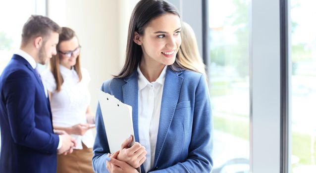 Face of beautiful woman on the background of business people