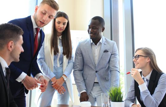 Multiethnic group of young people putting their hands on top of each other. Close up image of young business people making a stack of hands.