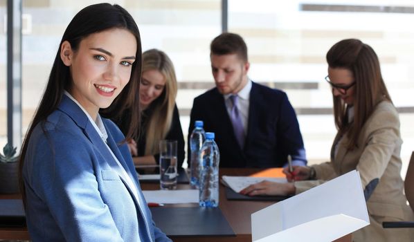 business woman with her staff, people group in background at modern bright office indoors.