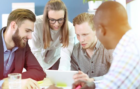 Image of business partners discussing documents and ideas at meeting