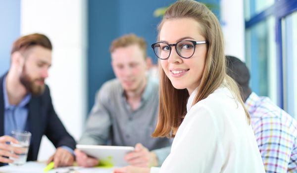 business woman with her staff, people group in background at modern bright office indoors