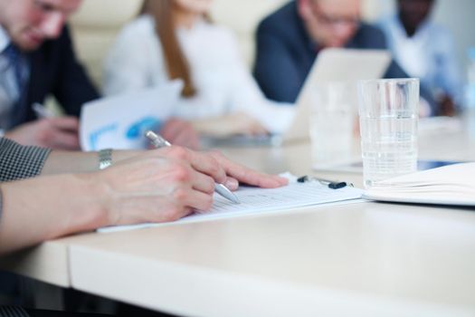 Unrecognizable business person analyzing graphs and taking notes