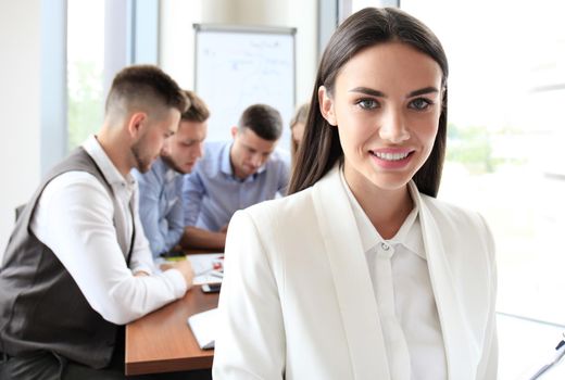 Face of beautiful woman on the background of business people