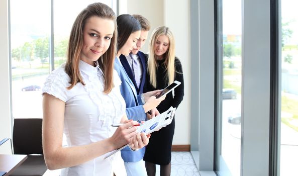 Face of beautiful woman on the background of business people