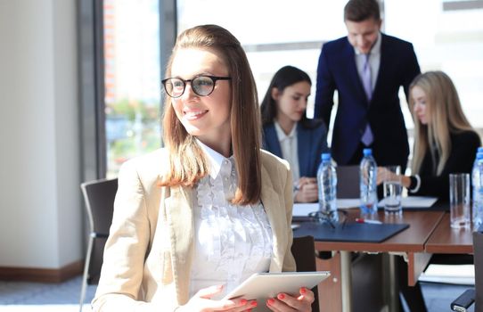 business woman with her staff, people group in background at modern bright office indoors.