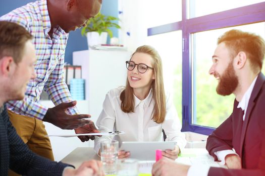 Image of business partners discussing documents and ideas at meeting