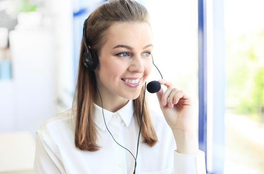 Portrait of call center worker. Smiling customer support operator at work.