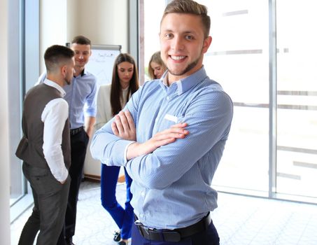 Businessman with colleagues in the background in office