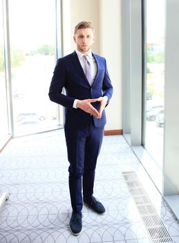 Young handsome businessman smiling in an office environment