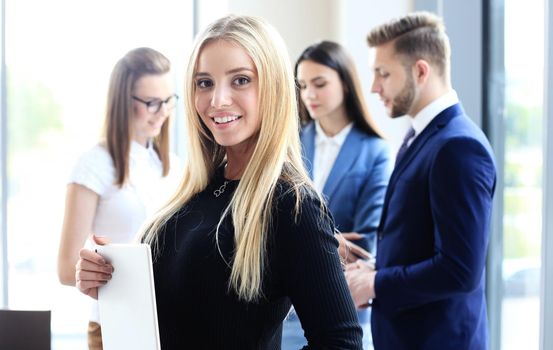 Face of beautiful woman on the background of business people