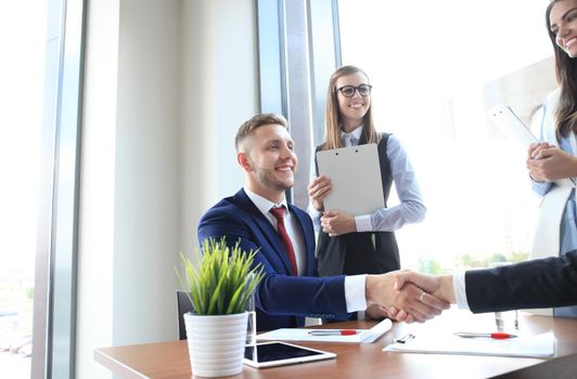 Business handshake. Two businessman shaking hands in the office.