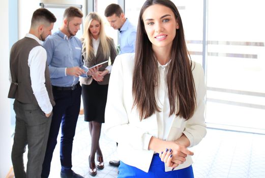 Face of beautiful woman on the background of business people