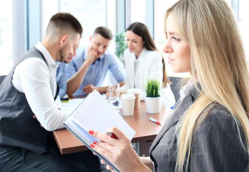 Face of beautiful woman on the background of business people