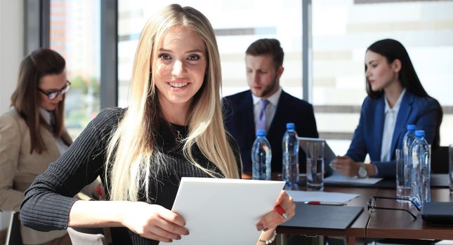 business woman with her staff, people group in background at modern bright office indoors.