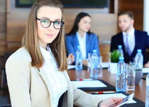 business woman with her staff, people group in background at modern bright office indoors.