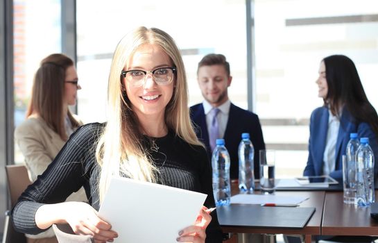 business woman with her staff, people group in background at modern bright office indoors.