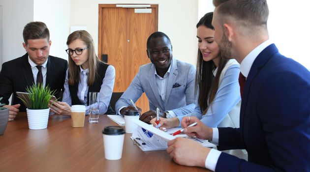 group of business people at a meeting on the background of office