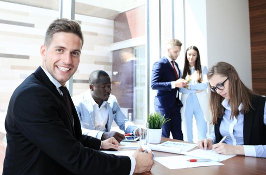 Businessman with colleagues in the background in office