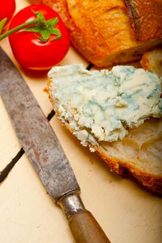 fresh blue cheese spread ove french baguette with cherry tomatoes on side