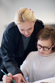 female teacher helping students on class about lessons and give support