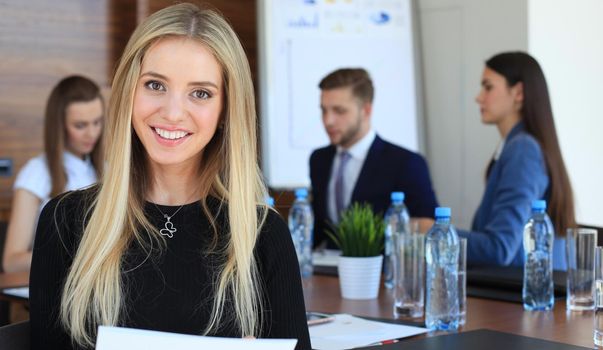 business woman with her staff, people group in background at modern bright office indoors.