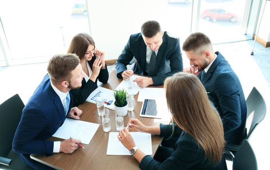 startup business team on meeting in modern bright office interior brainstorming, working on laptop and tablet computer