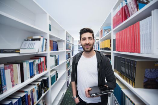 portrait of student in school  library with tablet computer. Database and archive management business concept