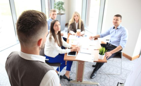 Businessman giving a presentation on flipchart. Teamwork concept