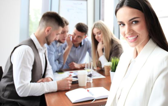 Face of beautiful woman on the background of business people