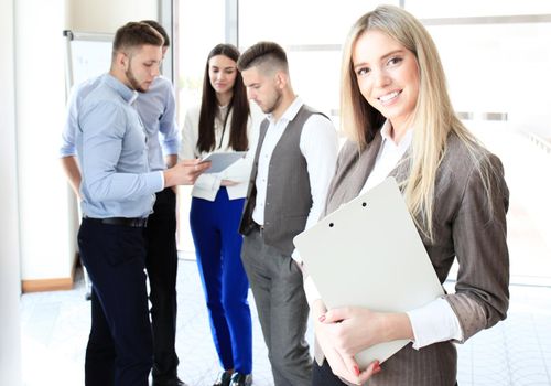 Face of beautiful woman on the background of business people