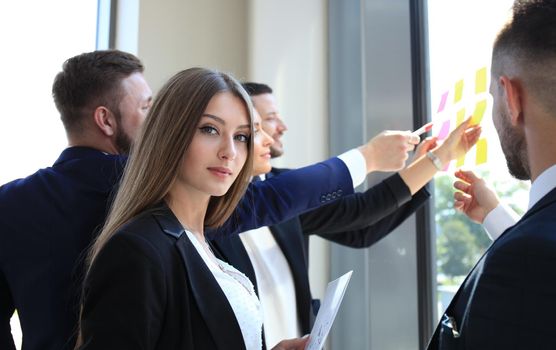 business woman with her staff, people group in background at modern bright office indoors