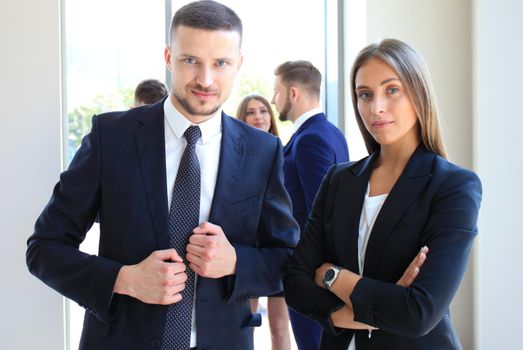 Group of business people at a meeting on the background of office. Focus on a beautiful brunet