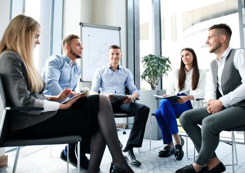 Business team discussing together business plans in office