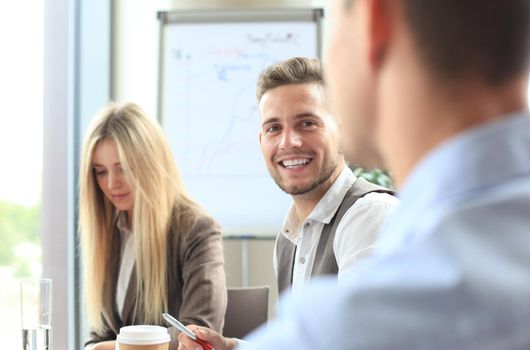 Business people Having Meeting Around Table In Modern Office