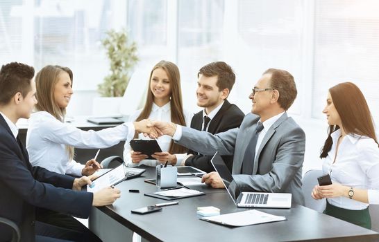 group of businessmen discussing the policies the company shaking hands with each other