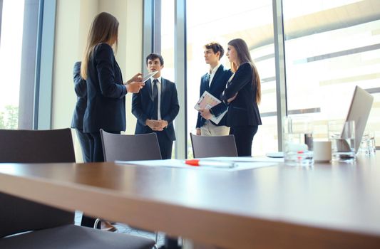 Team young professionals having casual discussion in office. Executives having friendly discussion during break.