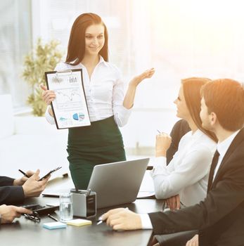 successful business team discussing work on the work plan, business woman acts with the presentation of profit growth
