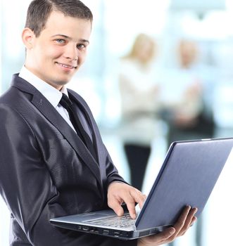 Happy smart business man with team mates discussing in the background