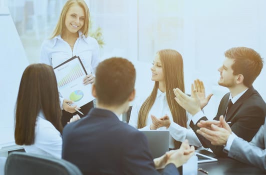business woman with a successful business presentation in a modern office with colleagues oplodismentami on business in a modern office