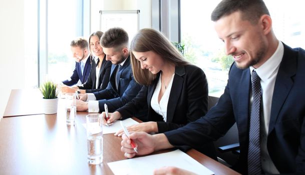 Image of row of business people working at seminar