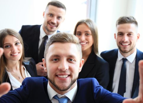 People taking selfie at business meeting