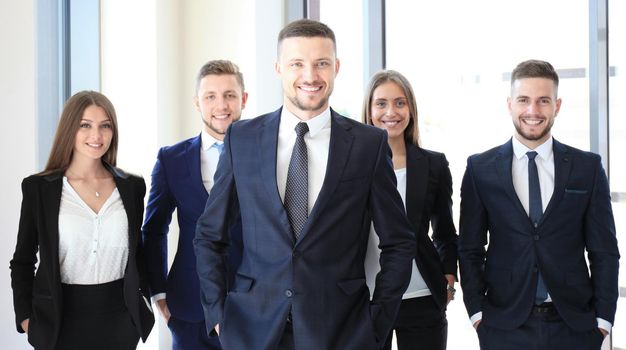 Happy smart business man with team mates discussing in the background