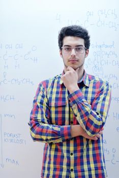 happy young teenage boy portrait in school on chemistry classes and library